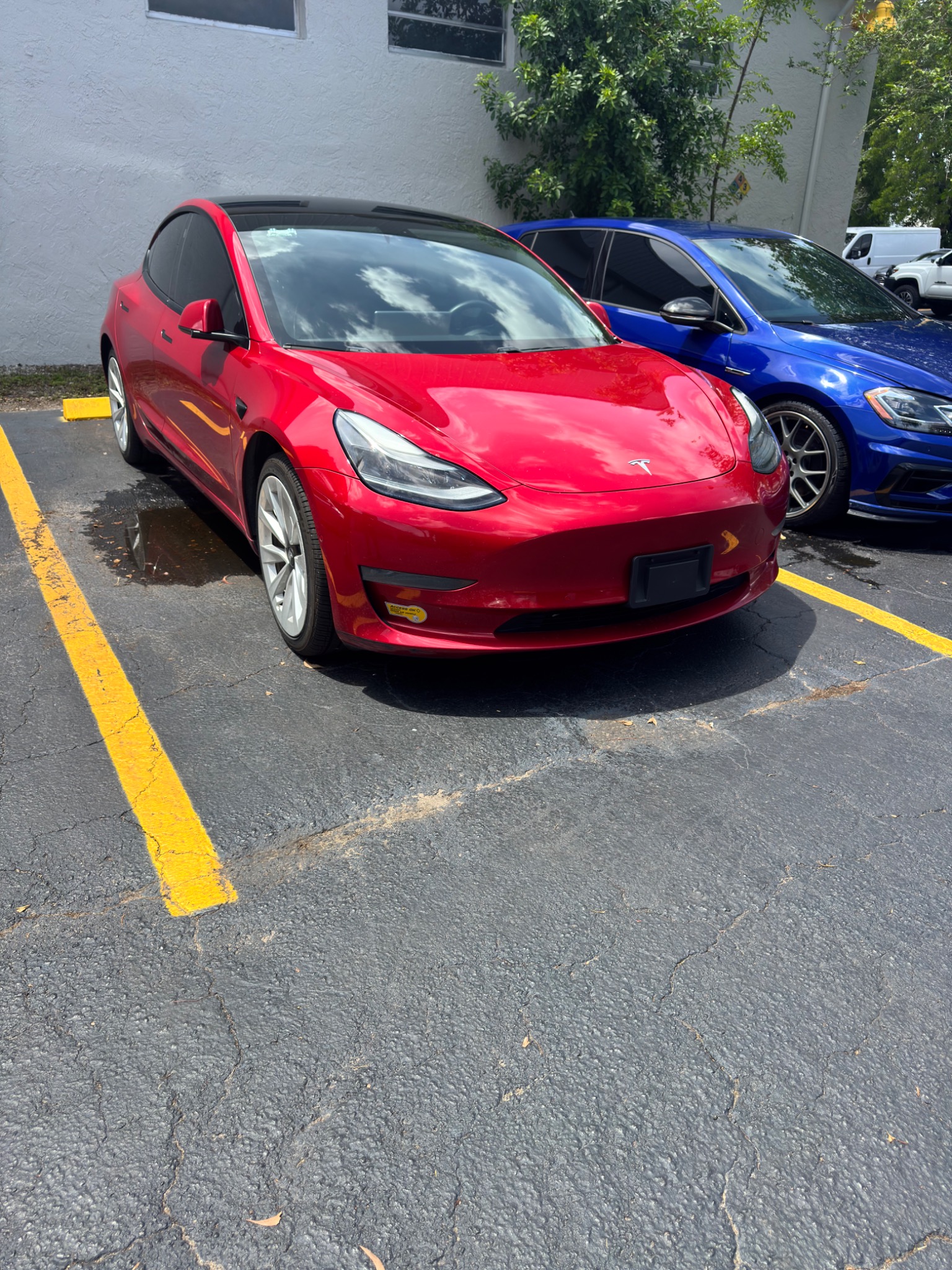 Tesla Model 3 red customer vehicle at TSL EV Center Lauderhill South Florida